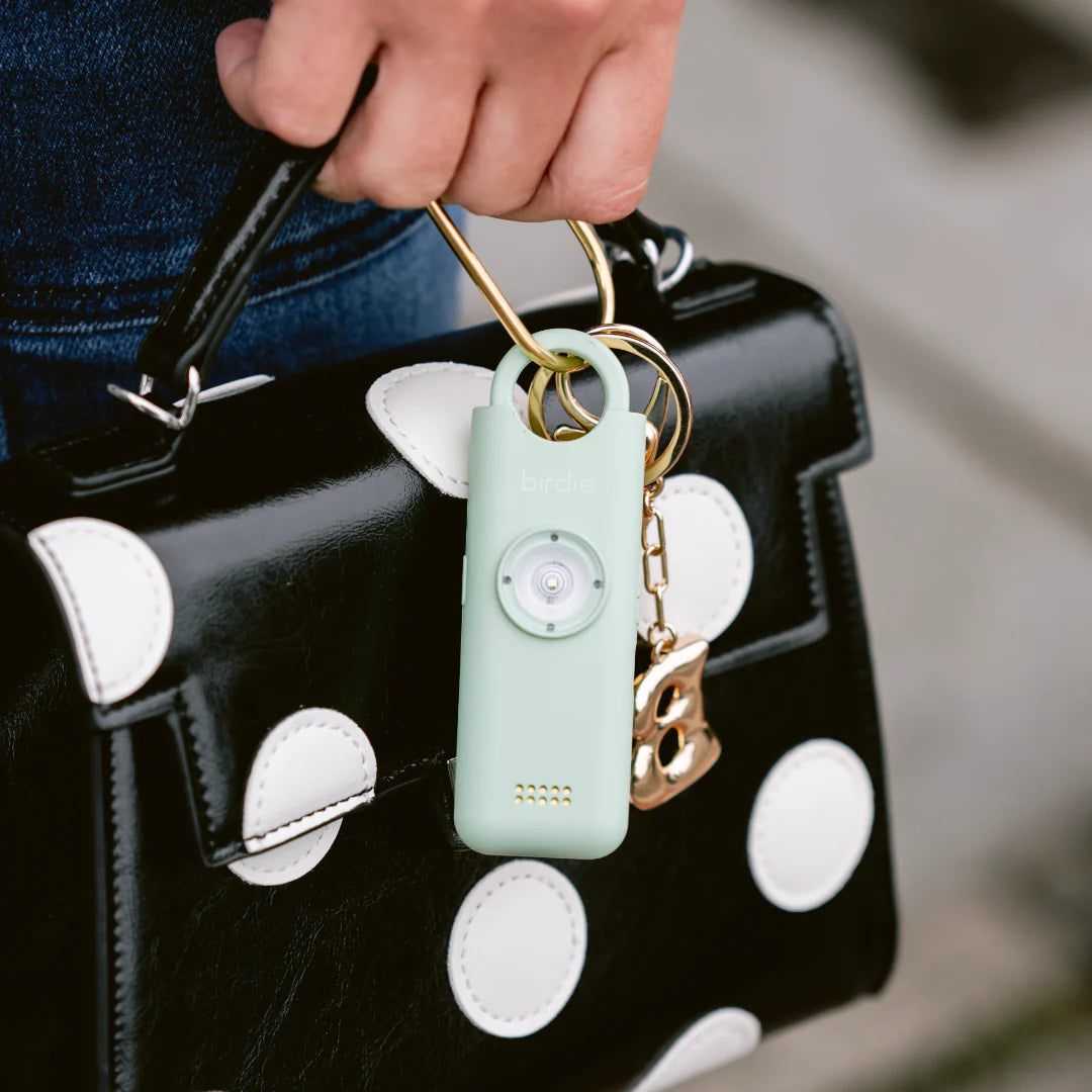 Birdie personal safety alarm on a bag